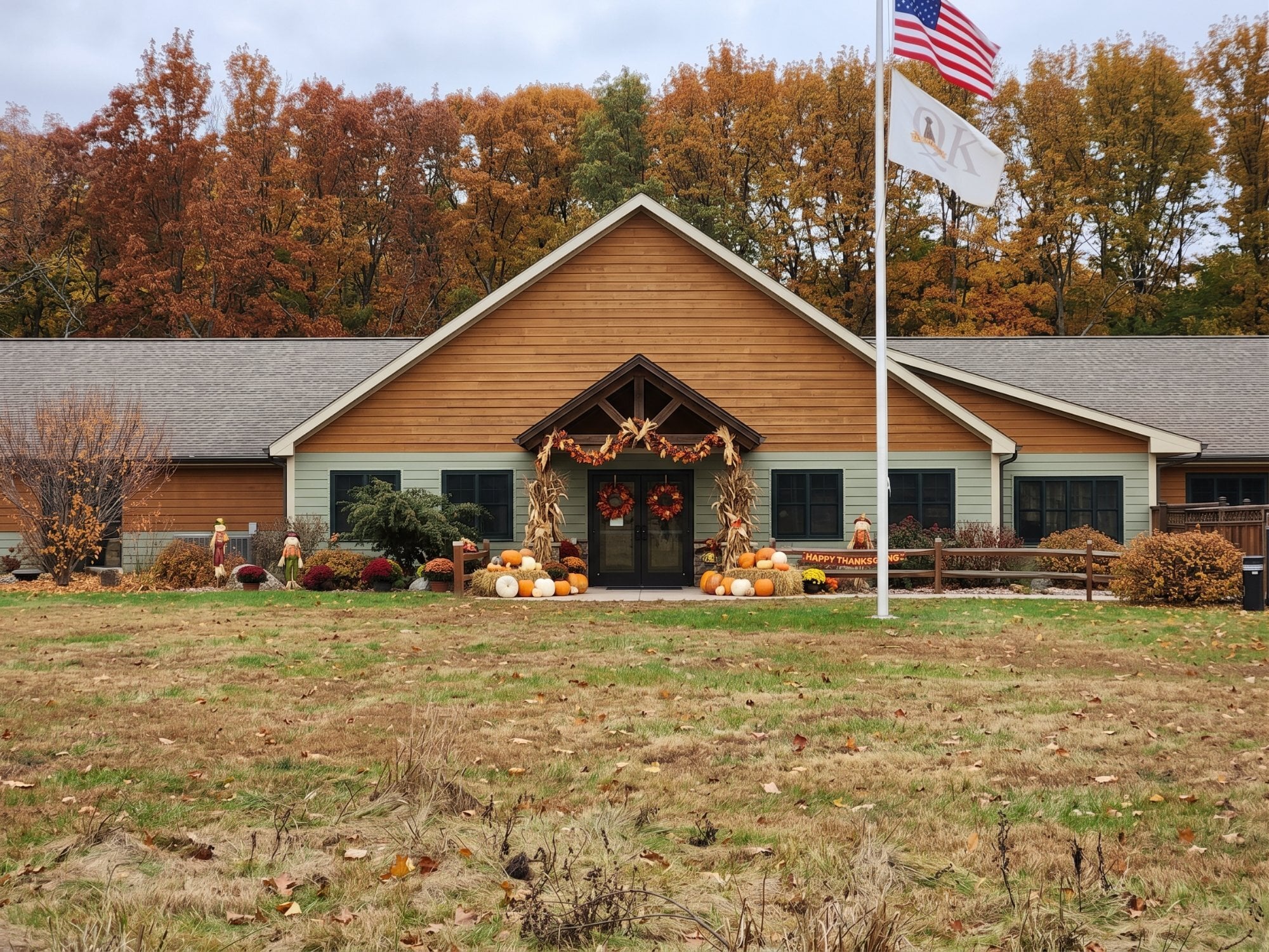 The QK Dogs facility decorated for Thanksgiving with pumpkins, cornstalks and fall foliage